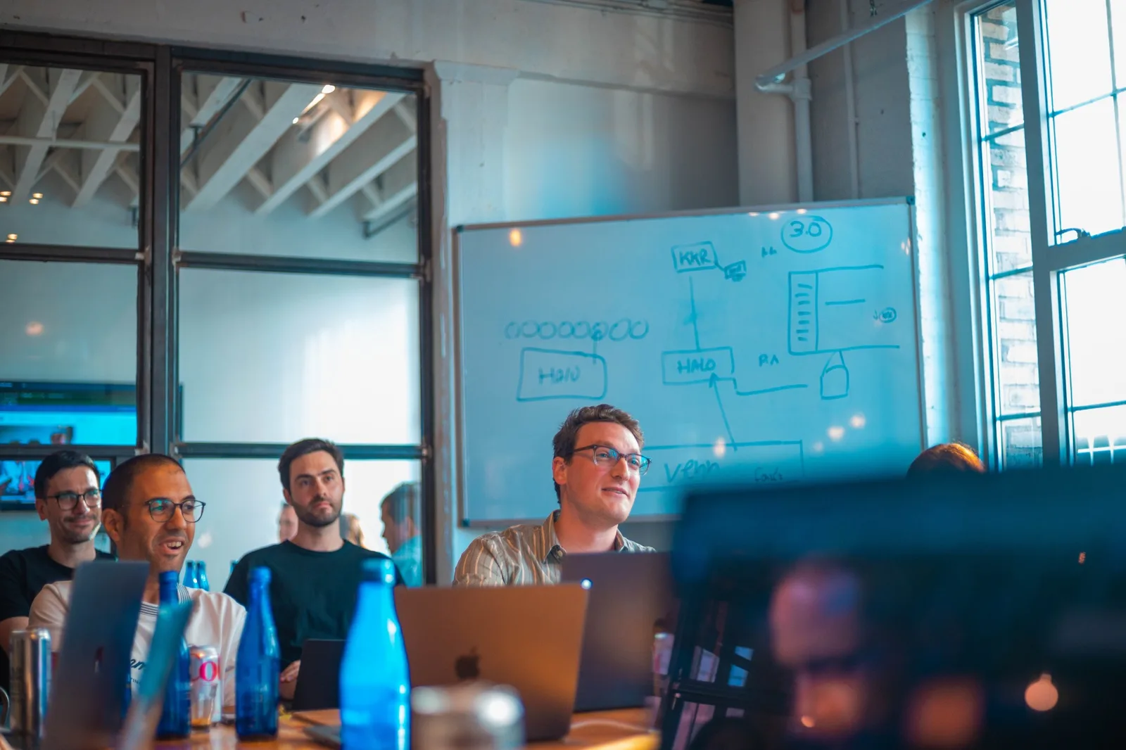 The Venn and Zuma teams reviewing the integration plan on a whiteboard